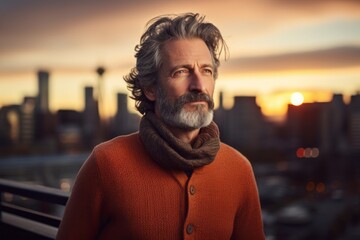 Wall Mural - Portrait of a blissful man in his 50s dressed in a warm wool sweater in vibrant city skyline