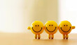 Yellow smiling balls holding hands.
