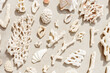 Seashells and corals as minimal pattern. Stylish layout of found shell and coral on ocean shore. Summer relahation concept, beach vibes. Top view nature background, neutral white beige tones gradient