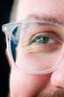 Macro Studio Expression Shot Of Young Man's Eye Wearing Glasses With Close Up On Eyelashes And Pupil