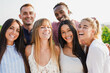 Group of multiracial people smiling on camera during summer time outdoor - Young friends hugging each other on countryside vineyard