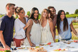 Group of adult multiracial people smiling in front of camera outdoor - Diverse friends having fun tasting vine during pic nic with vineyard and solar panels in background