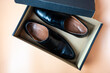 Male black leather shoe, new product on brown box, comfortable footwear for businessman or office workers. Open box