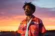 © CogniLens - Portrait of a content afro-american man in his 30s donning a trendy cropped top isolated in vibrant sunset horizon