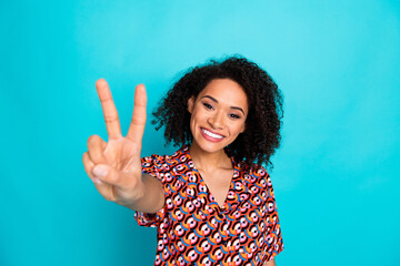 Sticker - Photo of adorable pretty lady wear print shirt showing you v-sign empty space isolated blue color background