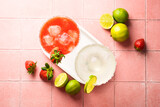 Fototapeta  - Margarita cocktails. Classic and strawberry margarita with tequila, ice and lime with ingredients at color background.