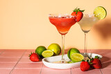 Fototapeta  - Classic and strawberry margaritas with tequila and lime at color background.