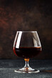Cognac at dark background. Strong alcohol drink.