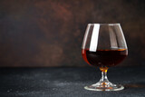 Fototapeta  - Cognac at dark background. Strong alcohol drink with copy space.