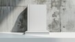 Front view of a white book mockup with a blank hardcover, positioned on a white table near a concrete wall. 3D rendering