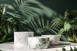 Marble podiums with tropical leaves on a green background.
