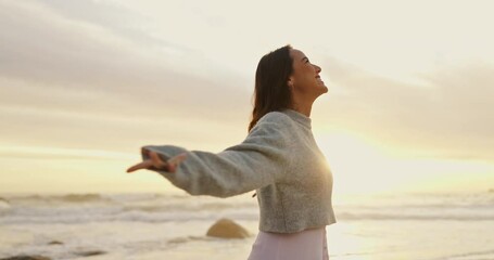 Wall Mural - Ocean, sunset and woman with smile for freedom in vacation, weekend holiday and journey in California. Summer, female person and happy with raised hands in beach for fresh air or peace outdoors