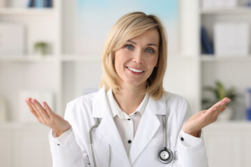 Wall Mural - Portrait of smiling doctor on blurred background