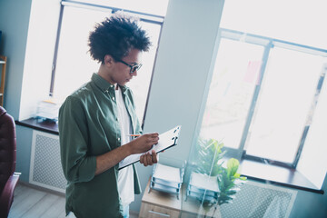 Sticker - Photo of clever intelligent manager wear khaki shirt glasses preparing contract writing clipboard indoors workshop workplace