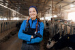 Concept banner vet worker of livestock farm. Portrait happy young woman veterinarian with phonendoscope on background milk cows