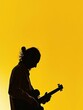 © Mickey - Passionate Musicians Silhouette in Harmonious Yellow Backdrop