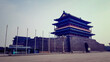 A panoramic view on a historic gatehouse Zhengyangmen, located on Tiananmen Square in Beijing, China. The construction consist of a high wall, and a house build on top of it. Defence building.