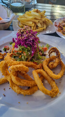 Fried rings of squid (calamari) and french fries in luxury gourmet restaurant near beach Playa Charco del Conde without people in Valle Gran Rey, La Gomera, Canary Islands, Spain, Europe