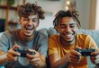  Two young men playing video games and laughing while sitting on the sofa at home, with their friends using game controllers in their hands. 