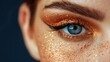   A close-up portrait of a woman with a striking blue eye accentuated by gold glitter and bold blue eyeliner