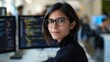© gn8 - A woman in glasses smiles at a computer monitor in a room