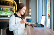 Happy of asian freelance people business female casual working with laptop computer and holding a coffee and smartphone in coffee shop like the background,communication concept