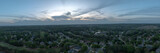 Fototapeta Miasto - 180 degree panorama of an upscale sub division in suburb of USA with lush green landscape shot during sunset in spring of 2024.