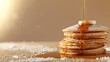 A tempting stack of fluffy pancakes, generously drizzled with flowing maple syrup and dusted with powdered sugar