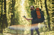 Beautiful lens effect. Bearded man is in the forest at daytime