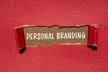 Personal branding words written on ripped red paper with brown background. Conceptual personal branding symbol. Copy space.