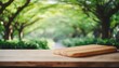 selective focus end grain wood counter top with cutting board on blur greeny tree garden in morning background for montage product display
