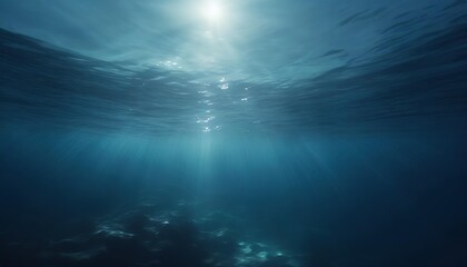 dark blue water of a deep sea with sun glare in the sky peaceful underwater landscape