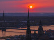 Magical aerial sunset over Riga old town, the capital of Latvia. Riga rooftop view panorama at sunset with urban architectures and Daugava River.
