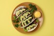 Delicious tacos with meat, vegetables and avocado served on yellow table, top view