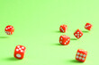 © New Africa - Many red game dices falling on green background