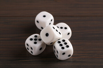 Sticker - Many white game dices on wooden table, closeup