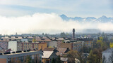 Fototapeta Londyn - Panoramic view of the rooftops of Nowy Targ with Tatra mountains in the background