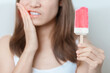 Teeth Sensitive to Cold concept. woman hold Ice cream and having toothache and pain after eat. Tooth Decay or Gum Disease, Grinding Teeth and Stress, Exposed Nerve Roots, Crack and Receding Gums