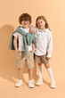 © New Africa - Fashion concept. Stylish children on pale orange background