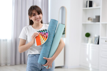 Poster - Woman with wallpaper rolls and color palette in room