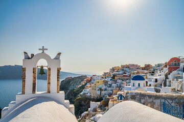 Sticker - Famous Santorini island bell towers against Oia village. Greece