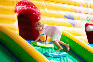 Wall Mural - Child jumping on playground trampoline. Kids jump.