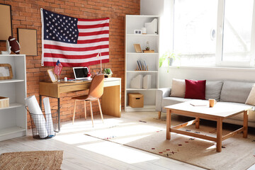 Canvas Print - Interior of modern office with workplace, sofa and USA flags