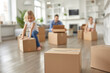 © Sergio - Group of people moving boxes in a living room