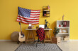 © Pixel-Shot - Interior of yellow office with workplace, laptop, guitar and USA flag