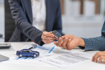 Asian businesswoman specializing in car loan services. Proficient in terms like extended warranty, lease, MSRP, and navigating financing options for customers' automotive needs.