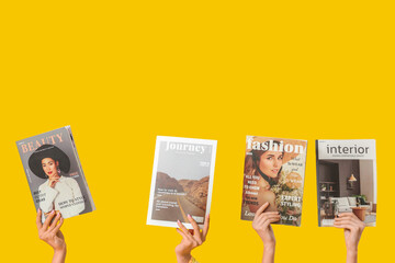 Poster - Female hands with different magazines on yellow background