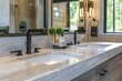 Modern bathroom vanity with marble top, black faucets, cabinetry and mirrors