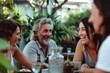 © Iigo - Group of friends having fun together at a restaurant. Cheerful senior man and women talking and laughing.
