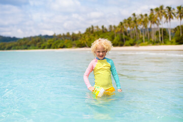 Wall Mural - Child on tropical beach. Sea vacation with kids.